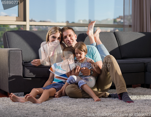 Image of happy young couple spending time with kids