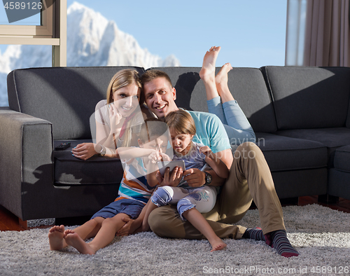 Image of happy young couple spending time with kids