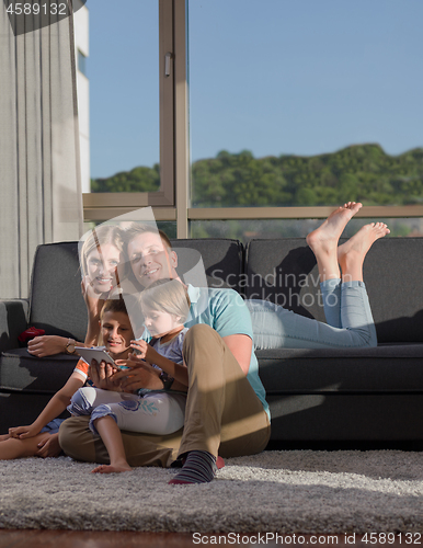 Image of happy young couple spending time with kids