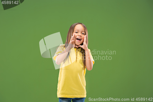 Image of Isolated on blue young casual teen girl shouting at studio