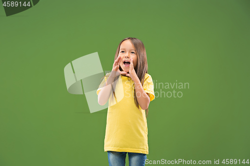 Image of Isolated on blue young casual teen girl shouting at studio