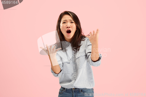 Image of Beautiful female half-length portrait isolated on pink studio backgroud. The young emotional surprised woman