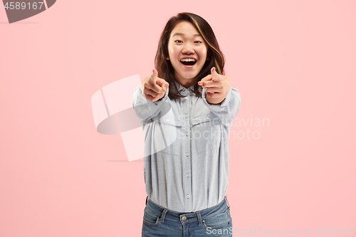 Image of The happy business woman point you and want you, half length closeup portrait on pink background.