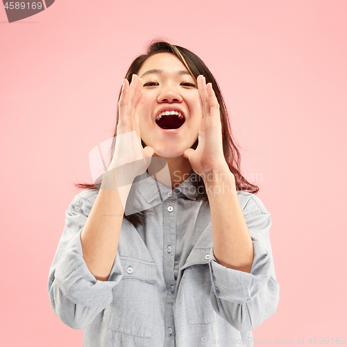 Image of Isolated on pink young casual woman shouting at studio