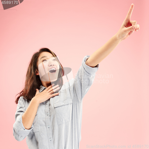 Image of Beautiful woman looking suprised isolated on pink