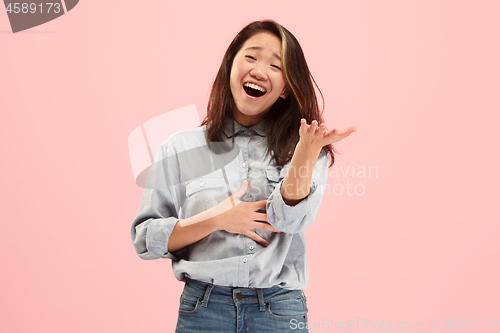 Image of Beautiful female half-length portrait isolated on pink studio backgroud. The young emotional surprised woman