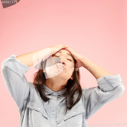 Image of Beautiful woman looking suprised and bewildered isolated on pink