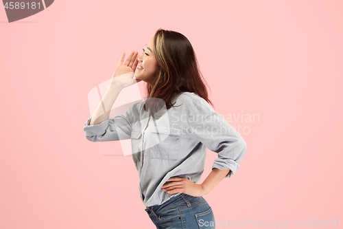 Image of Isolated on pink young casual woman shouting at studio