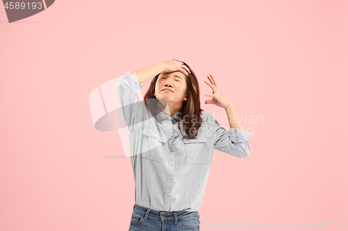 Image of Beautiful woman looking suprised and bewildered isolated on pink