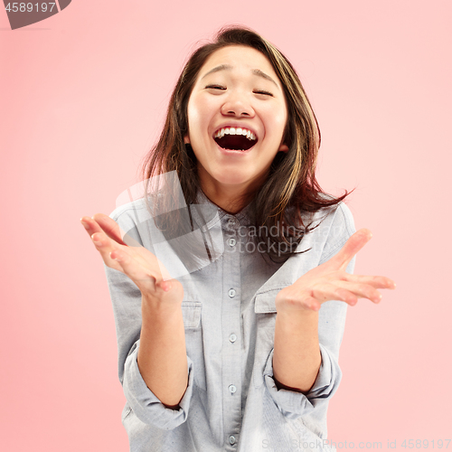 Image of Beautiful woman looking suprised isolated on pink