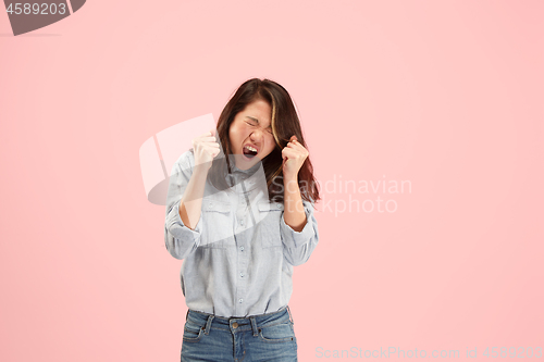 Image of Beautiful woman looking suprised and bewildered isolated on pink