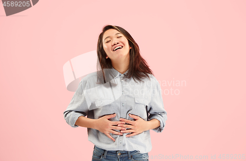 Image of Beautiful woman looking suprised isolated on pink