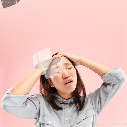 Image of Beautiful woman looking suprised and bewildered isolated on pink