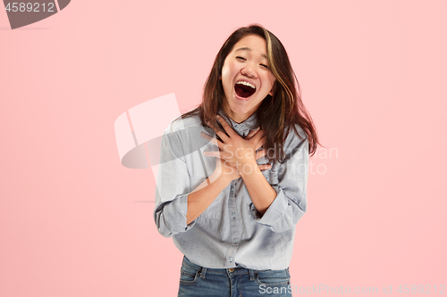 Image of Beautiful woman looking suprised isolated on pink