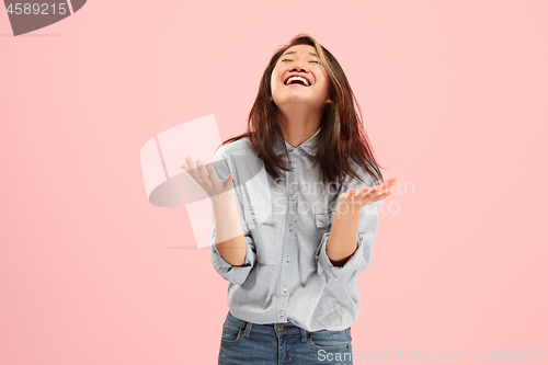 Image of Beautiful female half-length portrait isolated on pink studio backgroud. The young emotional surprised woman