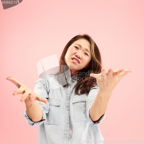 Image of Beautiful woman looking bewildered isolated on pink