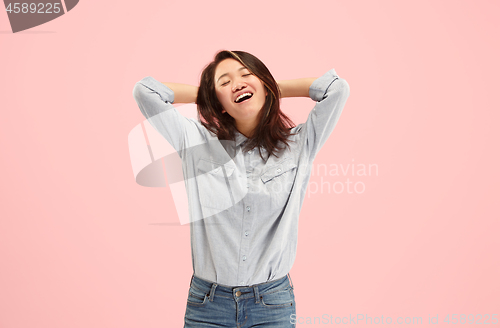 Image of Beautiful woman looking suprised isolated on pink