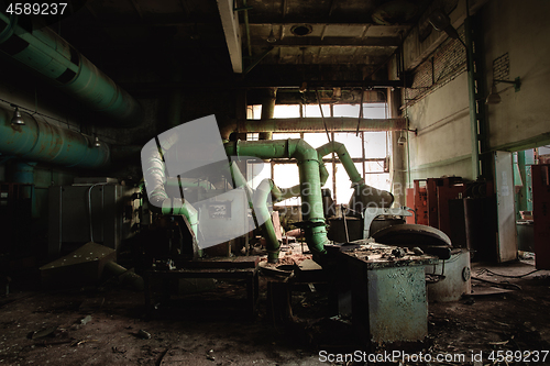 Image of Dark industrial interior with machinery inside