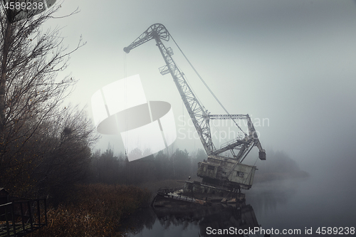 Image of Rusty old industrial dock cranes at the abandoned dock