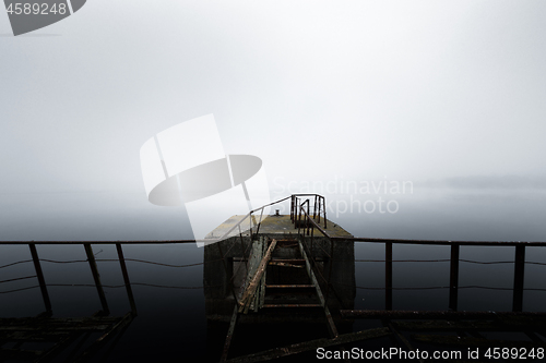 Image of Damaged pier in the mist at morning