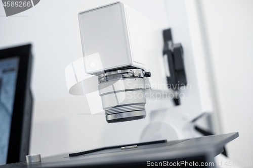 Image of White microscope close-up photo inside laboratory
