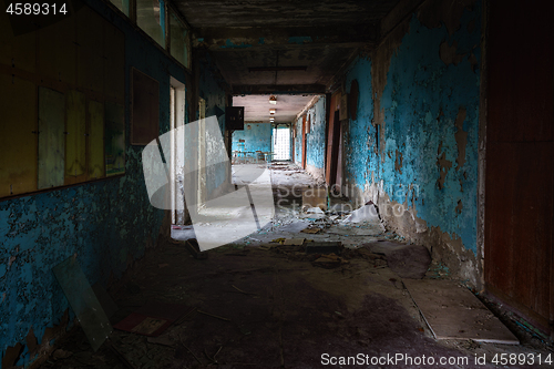 Image of Abandoned corridor in damaged building angle shot