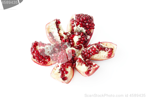 Image of Cut pomegranate fruit on white background