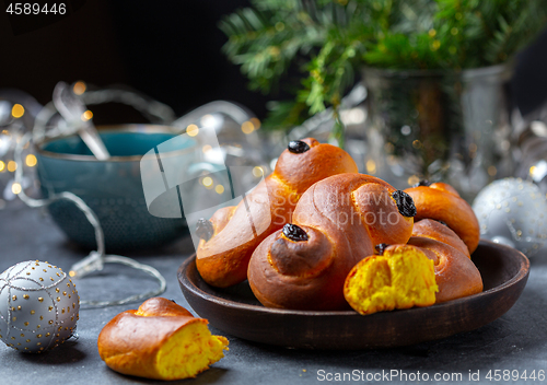 Image of Bun with saffron, a traditional Swedish lussebulle or lussekatt.