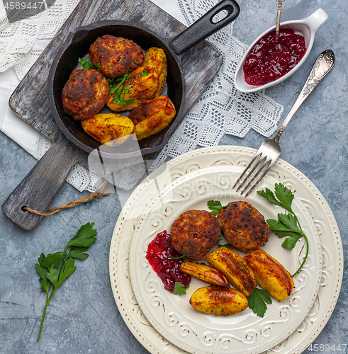 Image of Homemade meat cutlets and baked potatoes.