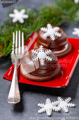 Image of Mini chocolate cakes with Christmas decorations.