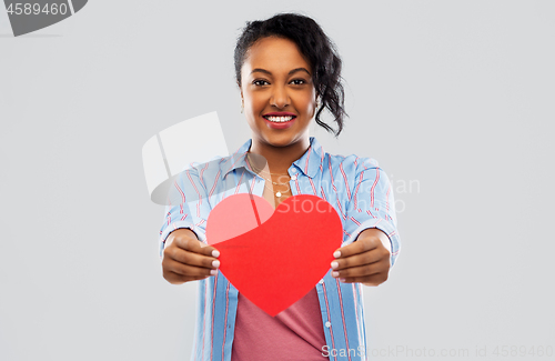 Image of happy african american woman with red heart