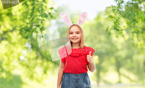 Image of girl wearing easter bunny ears showing thumbs up