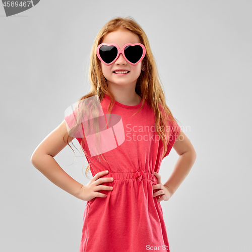 Image of smiling red haired girl in heart shaped sunglasses