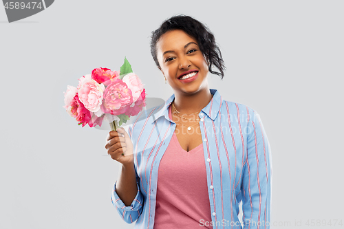 Image of happy african american woman with bunch of flowers