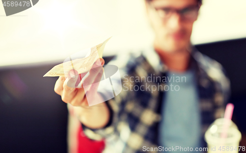 Image of happy man with cash money paying at cafe