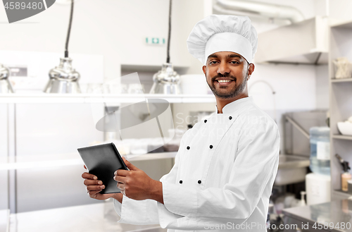 Image of indian chef with tablet pc at restaurant kitchen