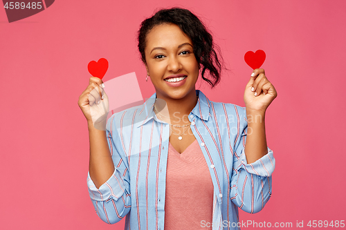 Image of happy african american woman with red hearts