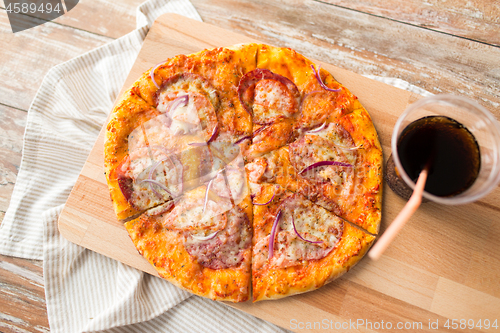 Image of close up of homemade pizza with cola on table