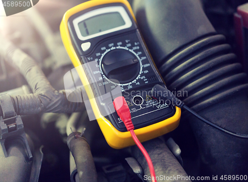 Image of multimeter or voltmeter testing car battery