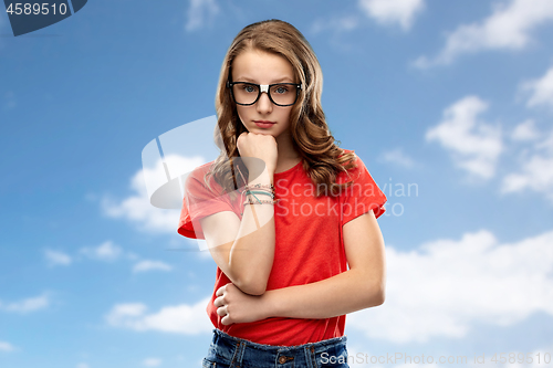 Image of student girl in glasses thinking over sky