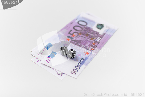 Image of close up of black dice and euro money