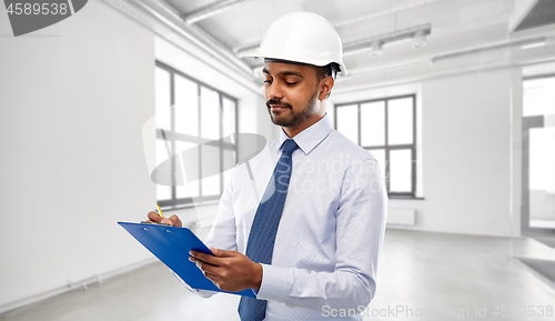 Image of architect or businessman in helmet with clipboard