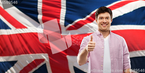 Image of happy man showing thumbs up over british flag