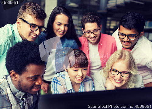 Image of international students with computers at library