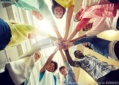 Image of group of international students with hands on top