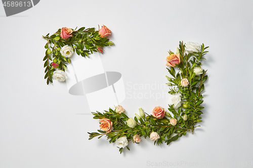 Image of Horizontal corner frame from evergreen twigs and flowers.