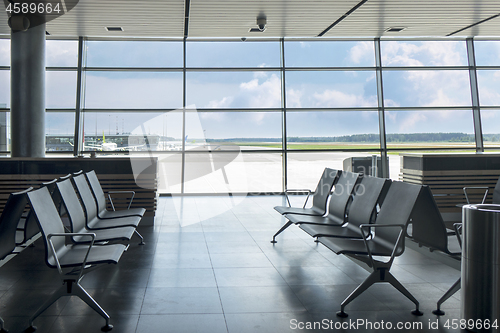 Image of Empty chairs at waiting area in the airport terminal.