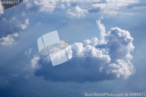 Image of Sun beams is lighting through the big white clouds.