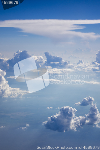 Image of Clear blue sky with big fluffy cumulus clouds.