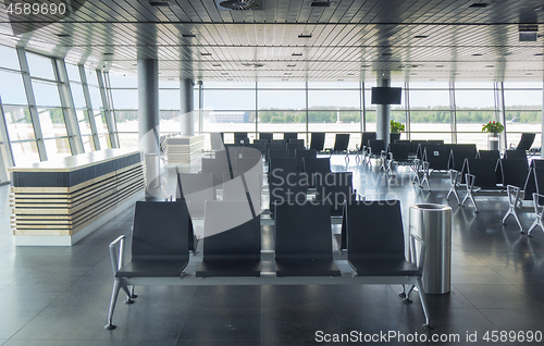 Image of Empty waiting hall in airport with lounge area.